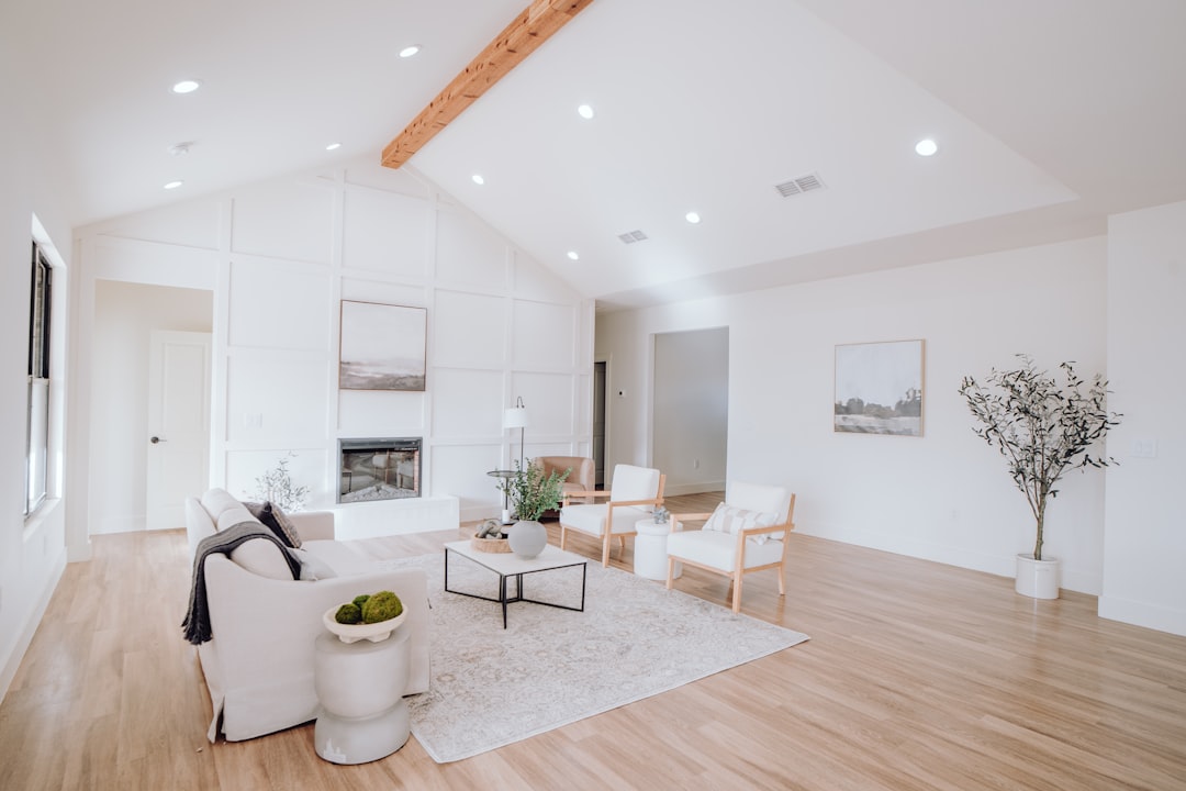 a-living-room-with-white-furniture-and-wood-floors-aq8ljlz12gk